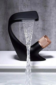 a faucet with water running out of it's side and a wooden spout