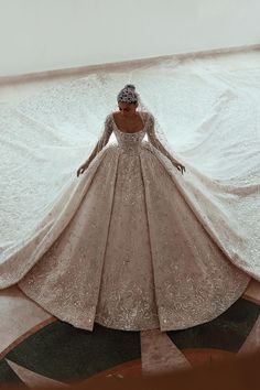 a woman in a wedding dress standing on the floor