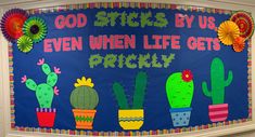 a bulletin board is decorated with colorful cactuses and saying god sticks by us even when life gets prickly