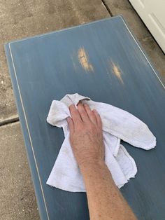 a person wiping their hands with a towel