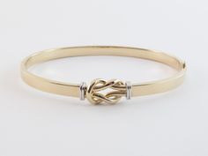 "Fabulous 14k Gold Love Knot Bangle Bracelet!! Material: Real 14k gold , Stamped 14k Weight: 7.10 grams Length: 7\" long Width: 10 mm wide on the knot and 5 mm wide on the tube Finish: Shiny yellow and white gold Closure: Hinged , Snap closure Gift box included Images may be enlarges to show details.Please pay attention to the photos and read description before the purchase. I ask you earnestly to make sure about measurements such as size , thickness, and length. Should you have any concerns or Adjustable 14k Gold Bracelet For Anniversary, Elegant Adjustable Gold Bracelet With Gold Clasp, Adjustable 14k Gold Bangle With 17 Jewels, 14k Gold Hallmarked Cuff Bracelet For Anniversary, Hallmarked 14k Gold Cuff Bracelet For Anniversary, Adjustable 14k Gold Bracelet For Formal Occasions, Elegant Bangle With Gold Clasp For Gift, Adjustable 14k Gold Bracelet For Wedding, Elegant Gold Clasp Bangle For Gift