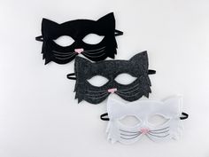 three masks with black and white cats on them