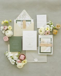 the wedding stationery is laid out with flowers