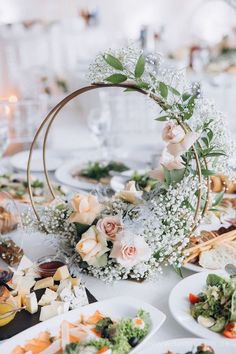 the table is set with flowers and plates