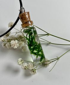 Introducing our Moss-in-a-Bottle Pendant - a wearable piece of nature's charm that encapsulates the tranquility of a miniature forest within a gracefully elongated, shatter-proof resin vessel. Inspired by the beauty of our Moss-in-a-Bottle Earrings, this pendant is a testament to the harmony between nature and jewelry craftsmanship. Crafted with meticulous detail, the pendant features real, vibrant green moss suspended in the crystal-clear resin, creating a mesmerizing and evergreen scene. The e Whimsical Green Jewelry For Gifts, Handmade Magical Green Jewelry, Handmade Fairycore Jewelry Gift, Handmade Magical Style Green Jewelry, Fairycore Earrings, Earrings Cottagecore, Cottagecore Earrings, Bubble Earrings, Terrarium Necklace