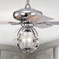 a ceiling fan that is hanging from the ceiling in a room with white walls and windows