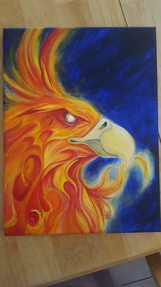 an acrylic painting of a lion's head on a wooden table top