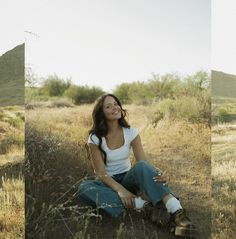 a woman sitting on the ground with her legs crossed and looking up at the sky