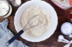 a bowl filled with flour next to other ingredients