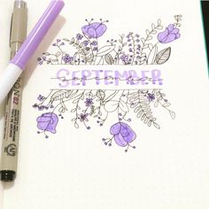 an open notebook with purple flowers and the words october written on it next to a pen