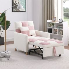 a living room with a white chair and pink checkered blanket on the back of it