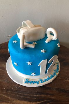 a blue birthday cake with white stars on it