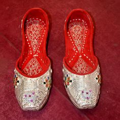 Handmade Pure Silver Women's Shoes | US Size 5 | Unique Stylish Footwear PRODUCT NAME ~ Pure Silver Women Jutti US Size 5 LENTH ~ 9.5 INCH MATERIAL ~ 925 Sterling Silver Step into the world of timeless Punjabi craftsmanship with our exquisite Punjabi Silver Jutti, a perfect blend of tradition and style. These stunning juttis are meticulously handcrafted to add a touch of ethnic elegance to your attire, whether you're dressing up for a special occasion or simply want to elevate your everyday look Silver Transitional Wedding Traditional Wear, Traditional Wear With Meenakari For Ceremonial Occasions, Ceremonial Traditional Wear With Pallu Details, Ceremonial Traditional Wear With Pallu, Festive Wedding Shoes With Round Toe, Silver Traditional Wear With Gota Work, Festive Wedding Shoes With Dori Work, Silver Traditional Wear With Gota Work For Wedding, Wedding Shoes With Dori Work For Festive Occasion