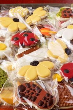 many decorated cookies in plastic bags on a table