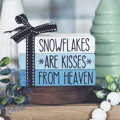 there is a sign that says snowflakes are kisses from heaven on the table