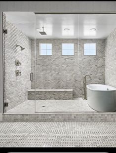 a large white bath tub sitting inside of a bathroom next to a walk in shower