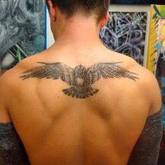 a man with an eagle tattoo on his back