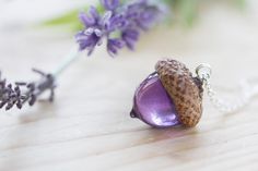 "A beautiful acorn necklace, in a gorgeous range of colours - the very most magical Wendy's kiss. The acorn is sculpted from a real acorn, and is capped with a real acorn cap, foraged from the base of a huge, friendly Oak tree. The actual acorn is made of UV stable jewellery-grade resin, so it is lightweight, but hardy. The acorn itself is 25mm across, and comes on an 18\" sterling silver chain. Longer chains are available here, if you like wearing your necklaces lower: https://www.etsy.com/uk/l Acorn Jewelry, Floating Diamond Necklace, Acorn Crafts, Acorn Pendant, Acorn Necklace, Real Flower Jewelry, Necklace Purple, Jewelry Resin, Purple Necklace