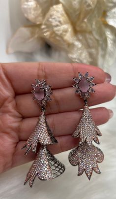 Beautiful American Diamond (AD) style Dangling Earring| Perfect for Wedding,Party wear | Indian, Pakistani,bridal jewelry.Mint ,Pink . Long Style AD Dangling Earrings. Material- American Diamond High End Quality 100% Satisfaction Guarantee: Long Lasting Plating, High-Quality Stones. Perfect for any occassion-Western, Indian and Casual day looks.    Colors Available- -Silver Pink - Silver Mint - RusticBlack Pink Care: It is advisable that you keep our products away from direct heat, humidity, and Elegant Silver Jhumkas For Wedding, Silver Jhumkas With Elegant Design For Wedding, Pink Hand-set Bridal Earrings For Wedding, Pink Hand Set Bridal Earrings For Wedding, Pink Hand Set Earrings For Celebration, Elegant Pink Dangle Jhumkas, Elegant Pink Drop Jhumkas, Elegant Pink Cubic Zirconia Flower Earrings, Formal Pink Round Flower Earrings