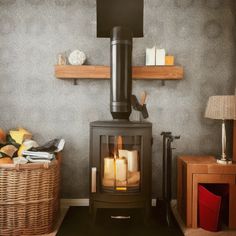 a wood burning stove in a living room next to two wicker baskets on the floor