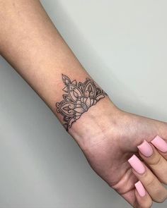 a woman's arm with a small tattoo on the left side of her wrist