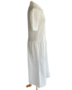 The perfect summer day dress. Relaxed fit with dropped waist, slightly tapered waist, long gathered skirt, button front closure, short sleeves, and collar. Handkerchief luxe linen, covered buttons. Small, Medium, Large Made in small batches, please allow up to 3 weeks for delivery is out of stock. Length can be shortened. For further questions or additional information, please email brigittehartdresses@gmail.com Fitted Linen Collared Midi Dress, Fitted Linen Midi Dress With Collar, Collared Linen Daywear Dresses, Collared Linen Dress For Daywear, Collared Linen Day Dress, Collared Linen Midi Dress For Daywear, Short Sleeve Midi Dress With French Seams For Daywear, Classic White Linen Midi Dress, Elegant Short Sleeve Linen Dress For Daywear