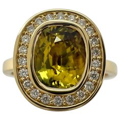 Unique GIA Certified Untreated Vivid Yellow Sapphire & Diamond 18k Yellow Gold Halo Ring Fine 2.12 carat natural sapphire with a fine vivid yellow colour and an excellent oval cut. This sapphire is fully certified by GIA confirming the sapphire as natural and untreated. This sapphire also has excellent clarity, very clean stone. VVS. This fine top grade sapphire is set in a beautiful bespoke made 18k yellow gold halo ring. The sapphire is accented by x20 1.1mm natural white diamonds. These are G/H colour and Si1 clarity. A beautifully crafted top grade piece. Ring size UK P - US7.25 - EU 56.5. The ring is re-sizeable. The ring is brand new and never worn. A unique piece. Fully hallmarked by Birmingham Assay Office. All our jewellery is posted safely and securely in leatherette boxes. Gold Halo Ring, Yellow Colour, Top Crafts, Gold Halo, Ring Unique, Yellow Sapphire, Multi Stone Ring, Halo Ring, Natural Sapphire