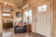 a living room filled with furniture and wooden walls