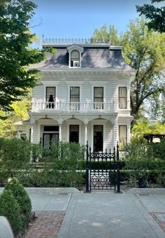 a large white house sitting on the side of a road