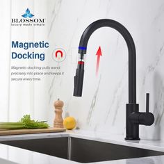 a black kitchen faucet with red handles and an arrow pointing to the right