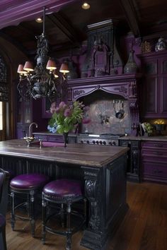 a kitchen with purple walls and wooden floors, an island table surrounded by stools