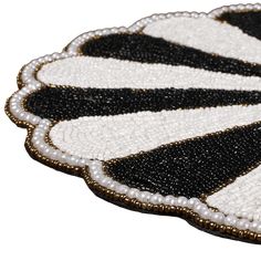 a close up of a black and white beaded object