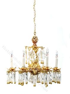 a gold chandelier with candles hanging from it