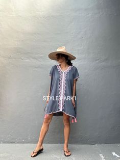 🙏🏻 please read measurement inch:Cm🙏🏻 This is a light soft comfy beautiful kaftan maxi dress. It is made of light soft Rayon  The dress  embroidery detail and tassel  Kaftan dress is perfectly in tune with the season's bohemian mood but is also a timeless choice for summer.  Photo -Model  size  Tall / 174cm /5.7 ft. Size fit - Medium Kaftan Dress size: USA /S~ L (one size) Color- Gray -tassel- Length - front& Back 92cm/36.22inch/3.01ft               Chest/140cm /55inch 4.59ft)round) 👉Dress i Vacation V-neck Kaftan With Tassel Ties, Bohemian Cover-up For Beach Season, Short Sleeve Beachwear Tunic For Vacation, Hippie V-neck Cover-up For Vacation, Summer Beachwear Kaftan With Back Tassel Tie-up, Casual Festival Cover-up With Tassels, Summer Boho Tunic Dress With Boho Print, Short Sleeve Beach Dress For Festival Season, Beach Season Festival Dress With Short Sleeves