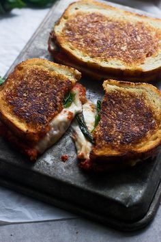 two grilled sandwiches with cheese and spinach