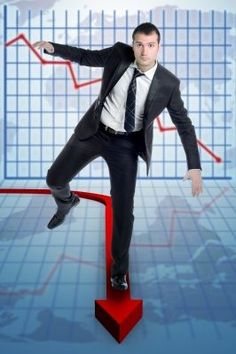 a man in a suit is standing on a red arrow