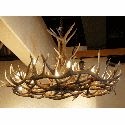 a chandelier made out of antlers hanging from the ceiling