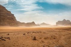 an empty desert with rocks and sand in the foreground