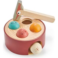 a wooden toy with different colored rocks in it