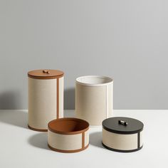 three different types of canisters sitting on a table