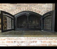 a fire place sitting inside of a brick fireplace