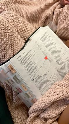 a person laying in bed reading a book