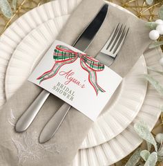 a white plate topped with silverware next to a fork and knife on top of a table