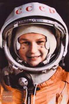 a man in an orange space suit is smiling