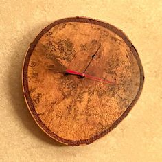 a clock made out of wood on the floor