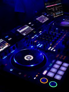 a dj's turntable in the dark with blue lighting