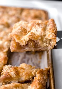 a close up of food on a pan with a spatula in the foreground