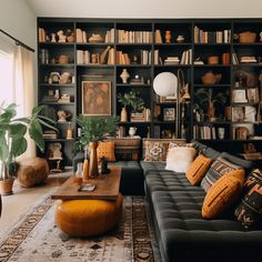 a living room filled with lots of bookshelves next to a couch and coffee table