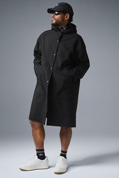 Stay dry without compromising style in this coat. It's stacked with functional features like a tall collar, a hood with bungees, zippered side pockets, and a secure zipper-and-snap front. Plus, it's made from soft, lightweight, 100 percent waterproof ripstop with a relaxed fit to accommodate movement. Cool on the streets? Yes. Suitable for stormy days? Also yes. Alo Yoga Hooded Outerwear For Winter, Alo Yoga Oversized Long Sleeve Outerwear, Workwear Parka With Detachable Hood, Alo Yoga Long Sleeve Spring Outerwear, Modern Black Parka With Detachable Hood, Alo Yoga Hooded Outerwear With Drawstring, Alo Yoga Fall Outerwear With Drawstring Hood, Alo Yoga Outerwear With Drawstring Hood For Fall, Alo Yoga Drawstring Hood Outerwear For Fall