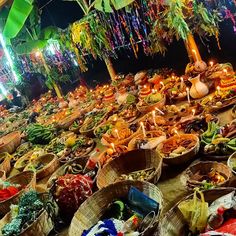 baskets filled with food sitting on top of a wooden table next to candles and streamers